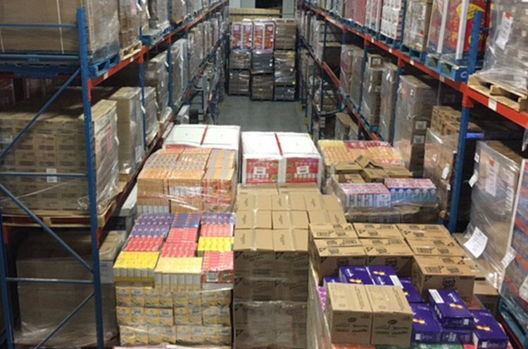 A warehouse filled with lots of boxes and shelves.