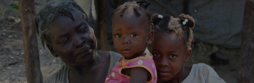 A woman and two children are standing together.