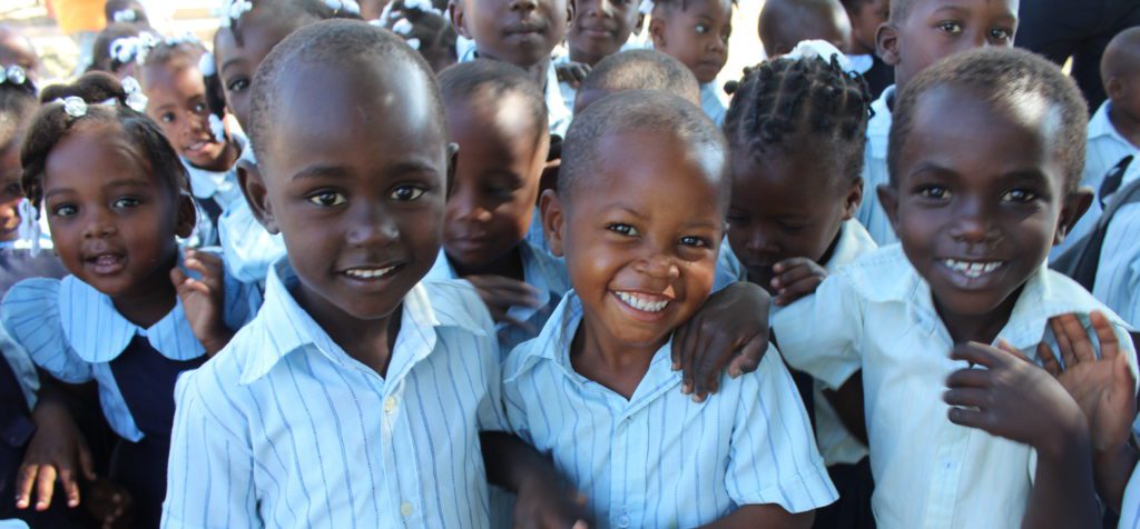 A group of children smiling for the camera.