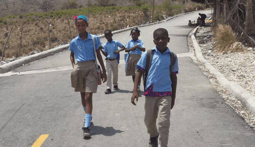 A group of young boys walking down the street.