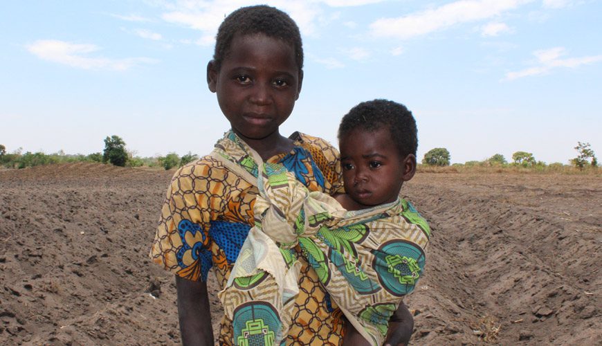 A young boy and his baby in africa