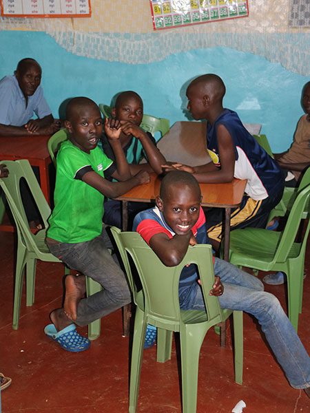 A group of young boys sitting at a table.