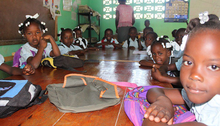 A group of children sitting on the floor.