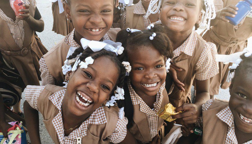 A group of children smiling for the camera.